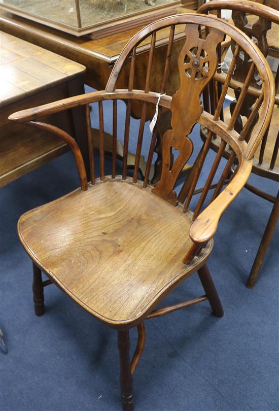 A set of four early 19th century yew, ash and elm wheelback Windsor armchairs,